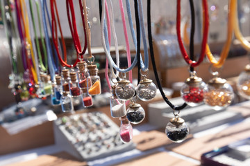 Pendants Spheres with bisteria stones in street market.
