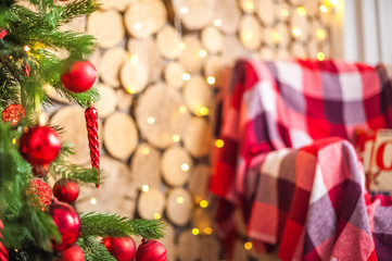 Details of the New Year's interior close-up and copy space. Living room with Christmas tree and presents with a red plaid.
