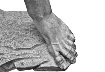 Foot. Fragment of an antique marble statue. Cracked ground in the background. Plaster limb, foot male with fingers, body part. Foots of ancient granite statue of man isolaated on white background