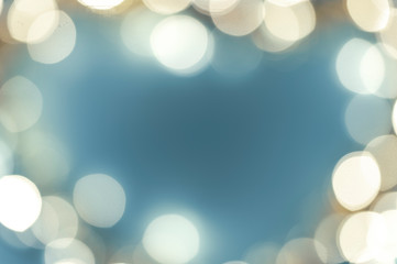 blurred lights in the shape of a heart on a blue background, abstract background image, space for text
