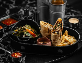 fried beef burrito with lettuce, cucumber, served with fries, and fresh vegetable salad