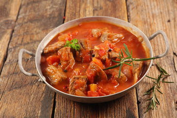 beef stew with tomato sauce and herbs