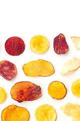 Dry fruit and vegetable chips, top shot with a place for text. Healthy vegan snack, an organic food flat lay pattern on a white background