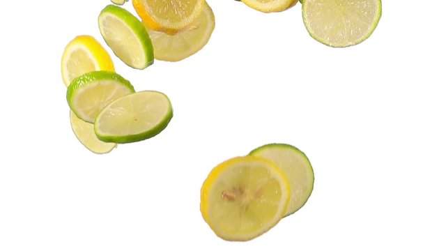 lemon and lime slices flying in super slow motion on white background