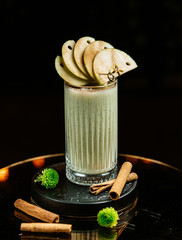 fresh apple juice topped with cinnamon sprinkles and apple slices