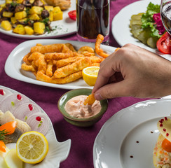 fried crispy braided cheese dipped into sauce served with lemon for beer snack