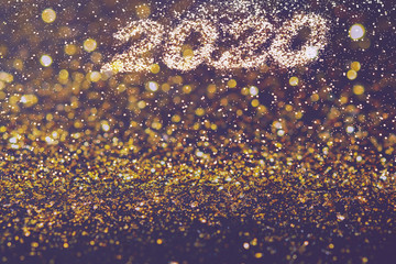 Abstract composition. Christmas, New 2020 year in golden glitter with beautiful bokeh on dark background