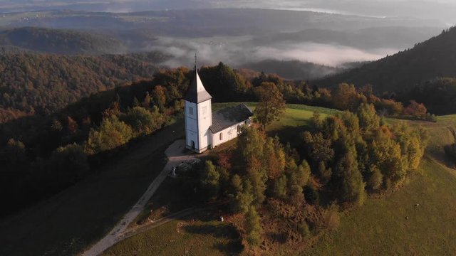 Autumn aerial view of a beautiful church on the top of a hill, in Slovenia