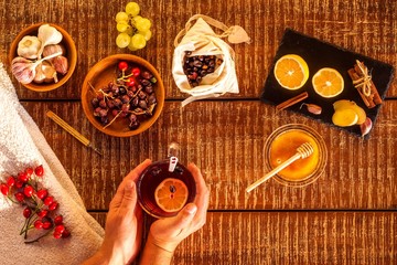 Cup of herbal tea on wooden background. Traditional medicine, flu  concept. Rosehip tea against cold and flu. Treatment of influenza. Flu epidemic.