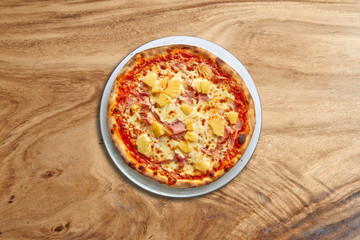 Delicious Hawai pizza on splendid wooden background