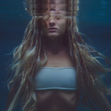 young woman in a swimsuit underwater
