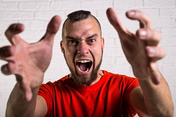 Portrait of young man screaming.