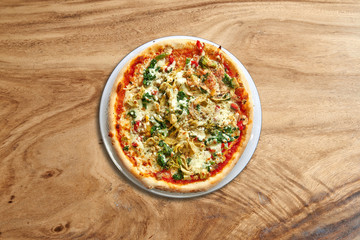 Delicious Vegetarian pizza on splendid wooden background