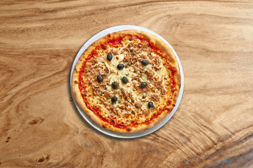 Delicious Toscane pizza on splendid wooden background
