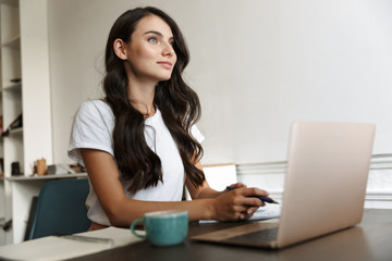 Woman indoors at home using laptop computer