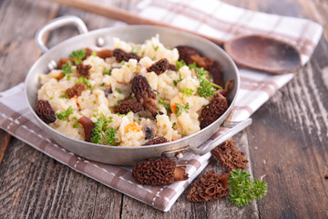mushroom risotto and herbs in pan