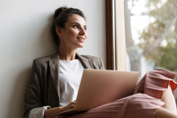Business woman indoors at home work with laptop