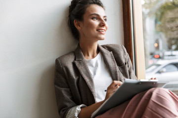 Business woman indoors at home work with documents.