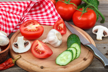 Fresh vegetables on a cutting board with a knife