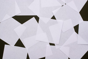 Several sheets of white paper on a black background close-up.