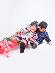 asian little girl and boy playing  Wearing yukata on white backgound