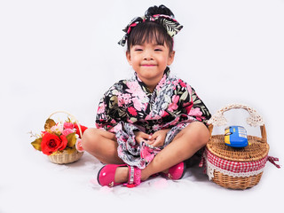 asian little girl  Wearing yukata with fruit basket on white backgound