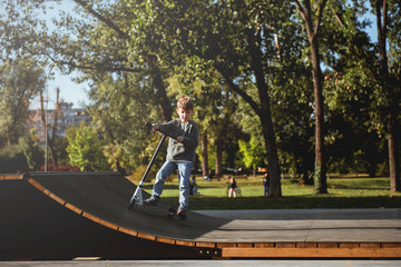 Portrait Of young Boy Riding Kick Scooter	