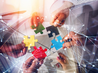 Business team connect pieces of puzzles. Teamwork, partnership and integration concept. double...