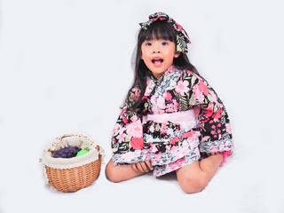 asian little girl  Wearing yukata with fruit basket on white backgound