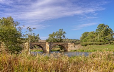 An old bridge crosses the River Derwent.
