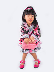 asian little girl  Wearing yukata with fruit basket on white backgound