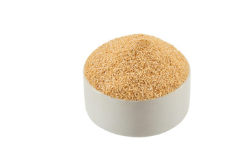 Ground garlic in a bowl isolated on white background with copy space for text or images. Spices and herbs. Packaging concept. Close-up.