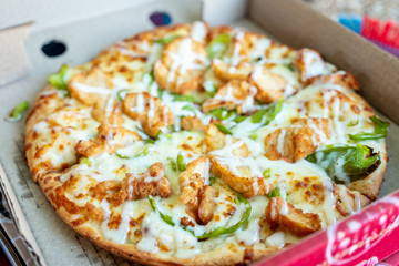 Happy arabic boys enjoying pizza together at the park