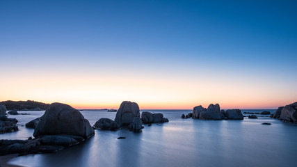 Fototapeta na wymiar Sunrise over boulders at Cavallo Island in Corsica
