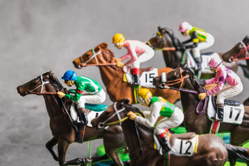 Galloping jockeys and race horses toy competing for position.Concept to compete for victory.