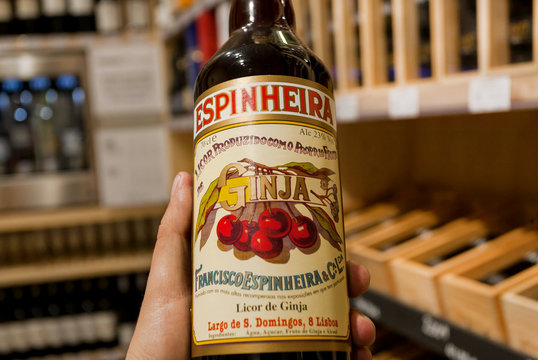 PORTO, PORTUGAL: Bottle of popular cherry liquor Ginja in the hands of the buyer of an alcohol store on 18 May, 2019. Portuguese language has 250 million total speakers