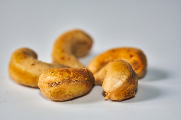 Baked cashew nuts on a white background