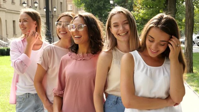 Happy women outdoors on sunny day, slow motion effect. Girl power concept