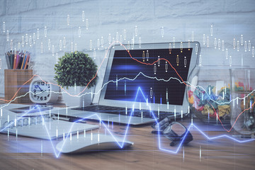 Double exposure of forex chart and work space with computer. Concept of international online trading.