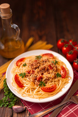 Pasta bolognese with tomato sauce and minced meat, grated parmesan cheese and fresh parsley - homemade healthy italian pasta on rustic wooden background.