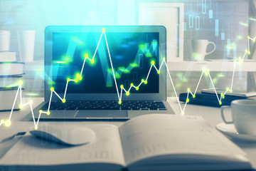 Stock market graph on background with desk and personal computer. Multi exposure. Concept of financial analysis.