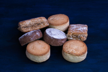 polvorones and angel hair shortbread on a dark wooden table . Typical Spanish sweet dessert. Christmas Holidays.
