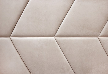 Beige velvet texture or background. Soft panels on the wall or headboard.