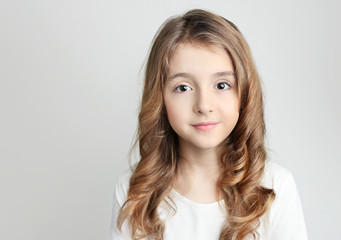 Caucasian child girl portrait on grey background empty copy space.