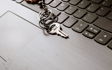 Close up of Still life of Key Ring on laptop computer keyboard. Conceptual image shown as network security key. Cyber Security, protection and privacy concepts.