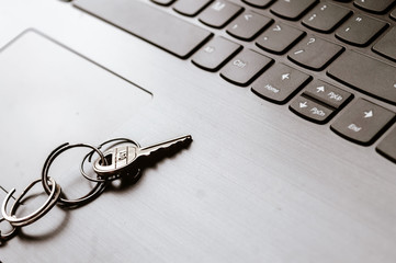 Close up of Still life of Key Ring on laptop computer keyboard. Conceptual image shown as network security key. Cyber Security, protection and privacy concepts.