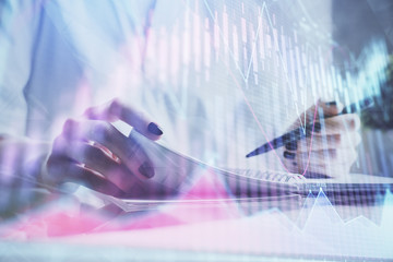 Financial chart drawn over hands taking notes background. Concept of research. Multi exposure