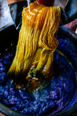 Thai traditional fabric process. Process of dye fabric indigo color. Indigo dye cotton thread in...