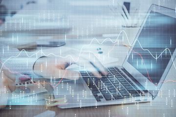 Multi exposure of stock market graph with man working on laptop on background. Concept of financial analysis.