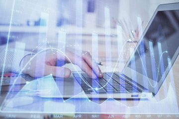 Plakat Double exposure of stock market graph with man working on laptop on background. Concept of financial analysis.